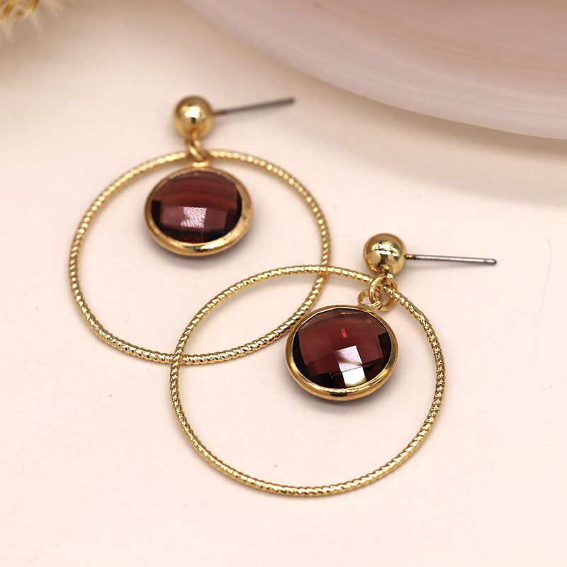 Golden textured hoop and red crystal earrings