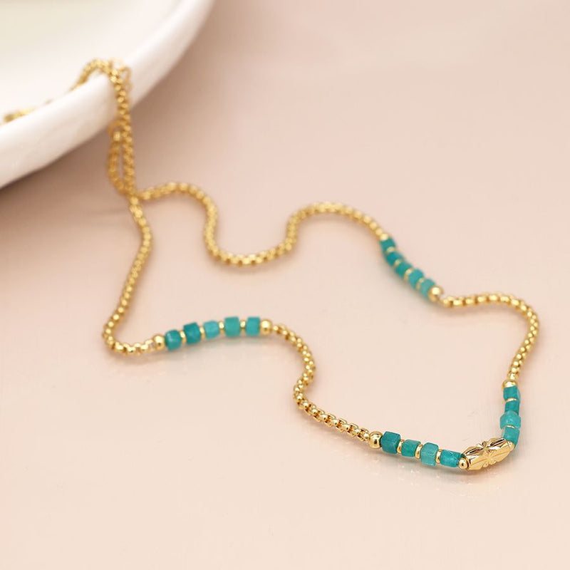 Golden chain and aqua bead station necklace