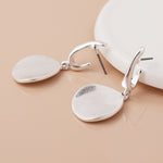 Silver plated worn disc drop earrings