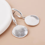 Silver plated worn disc drop earrings