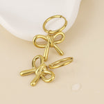 BELLE BOW HUGGIE EARRINGS - GOLD