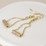 Golden crystal cylinder and chain earrings