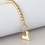 Golden bead and heart charm t-bar bracelet