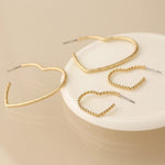 Golden mixed size textured heart earrings