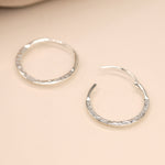 Sterling silver flat hammered hoop earrings