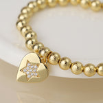 Golden beaded heart charm bracelet with pave crystal star
