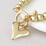 Golden bead and heart charm t-bar bracelet