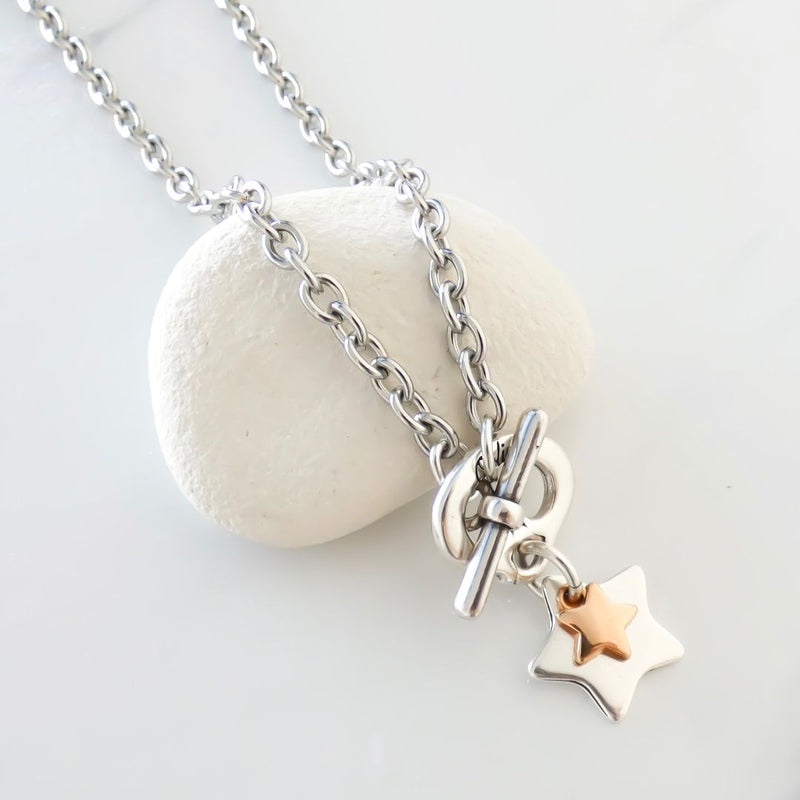 Fine oval chain t-bar necklace with a chunky star and mini star charm.
