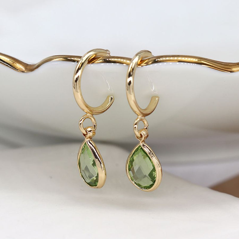 Golden hoop and green crystal drop earrings