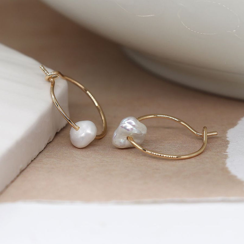 Golden wire hoop and seed pearl earrings