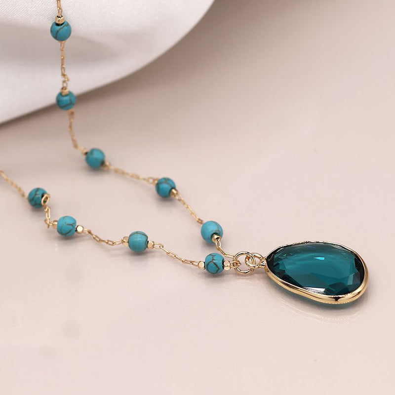 Golden turquoise bead necklace with teal crystal drop