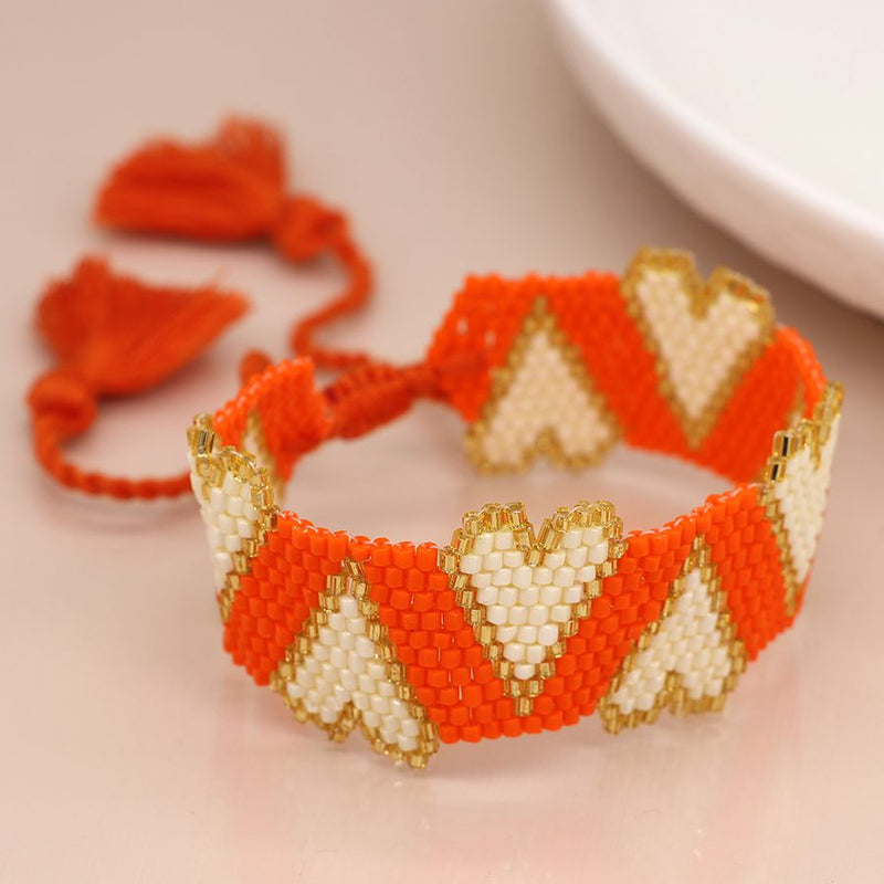 Orange bead and white hearts bracelet