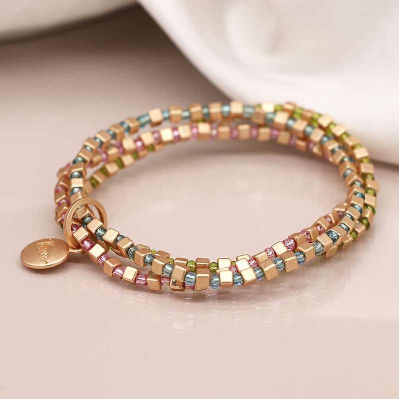 Triple layer golden cube, pink, blue and green bead bracelet