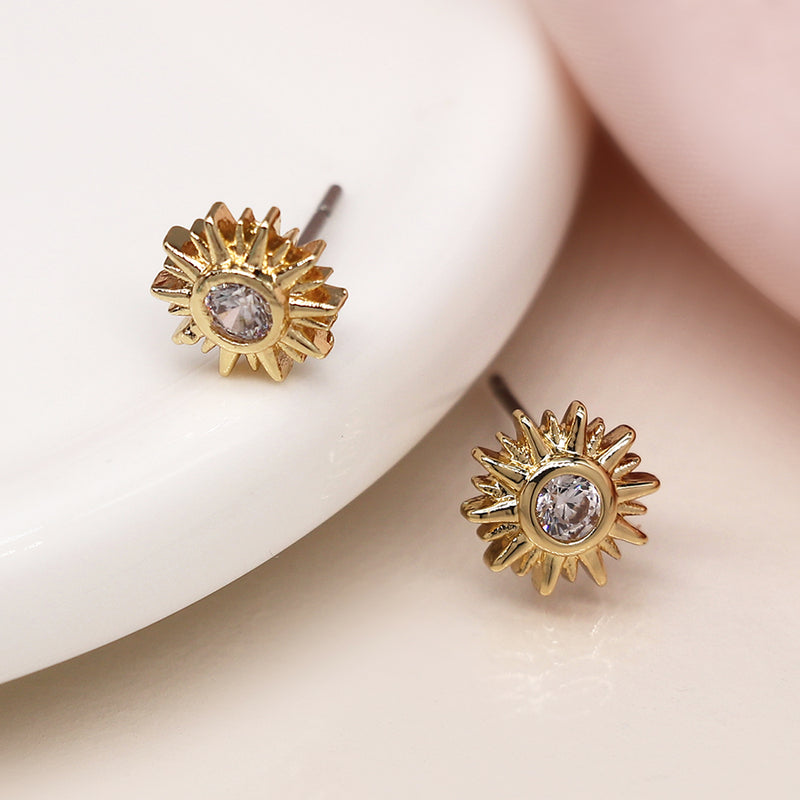 Faux gold sunburst stud earrings with crystal