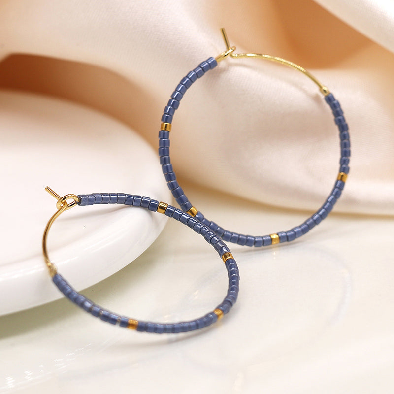 Faux gold open hoop and blue bead earrings