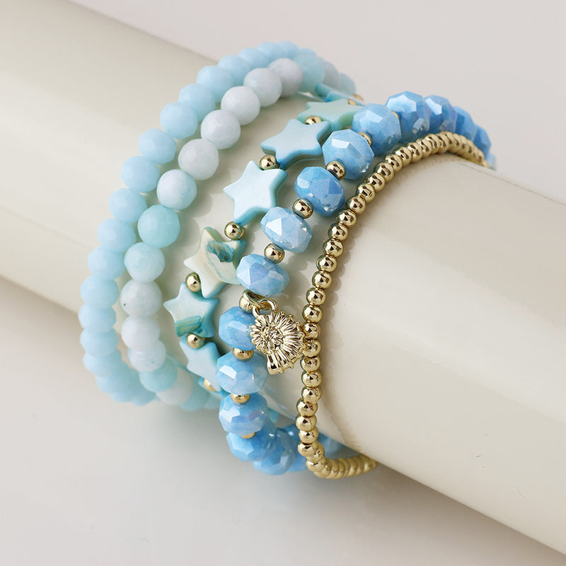 pale blue and gold bead bracelet stack with shell