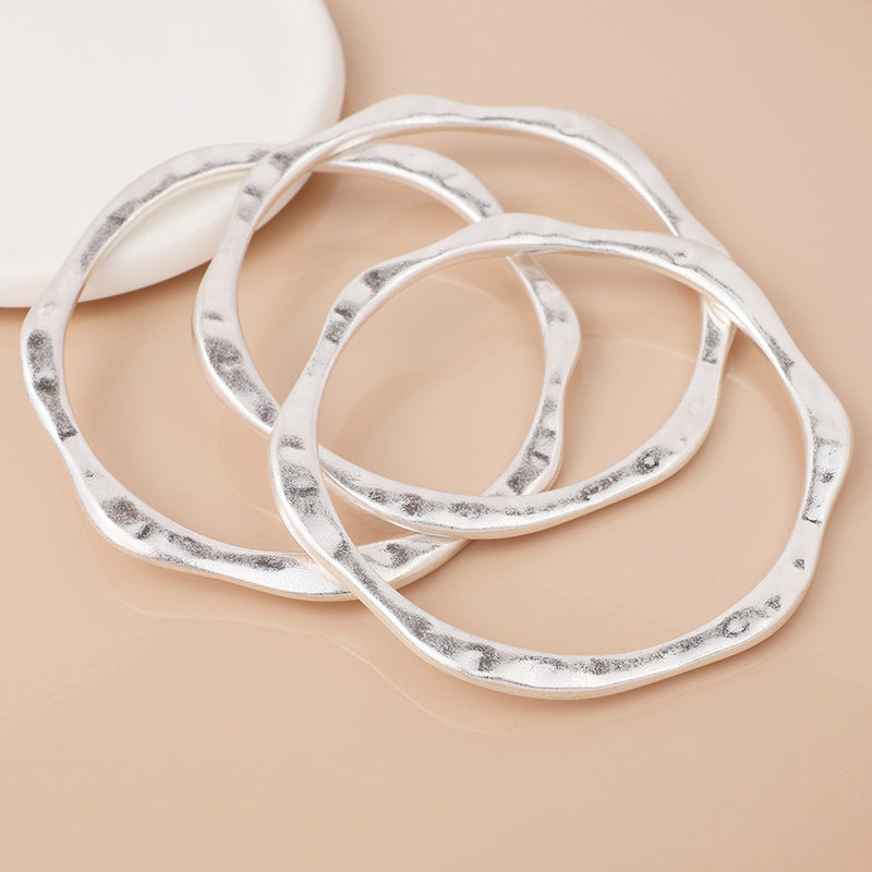 Silver plated wave edge worn bangle stack