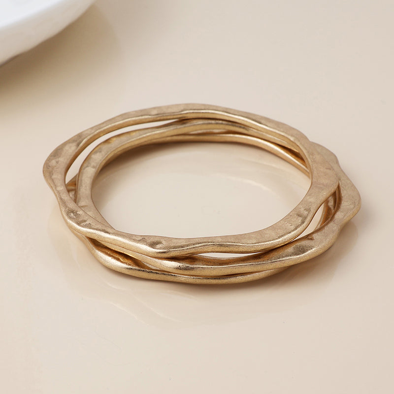 Golden wave edge worn bangle stack