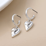 WORN SILVER BEATEN HEART DROP C POST EARRINGS