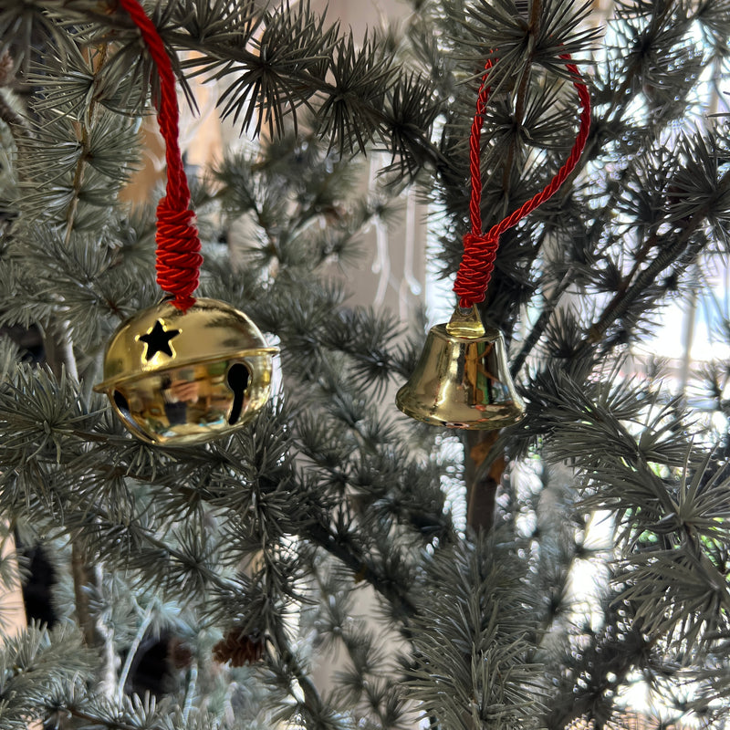 Brass bell on red rope tree decoration