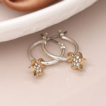 Golden pave stars and silver hoop earrings