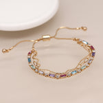 Golden multicoloured crystals and chains bracelet