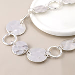Silver plated worn discs and hoops necklace