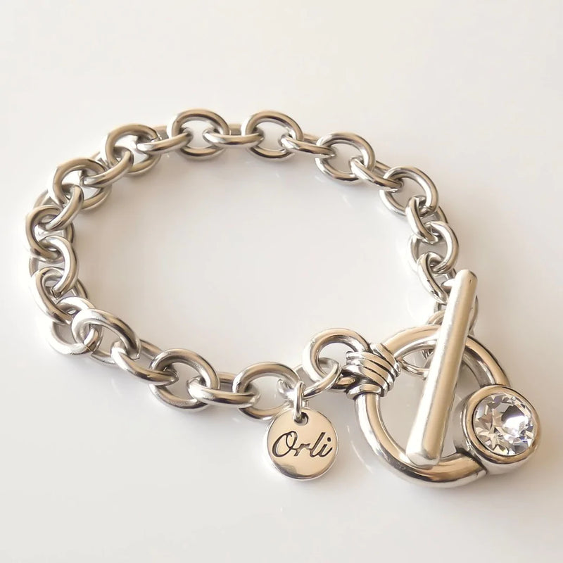 Chunky oval chain bracelet featuring a crystal t-bar fastener